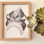 dessin au crayon noir et blanc - koala et son petit calin - style réaliste - arc en ciel brodé sur le papier sous le dessin